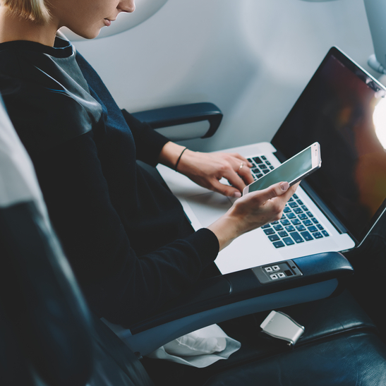 Traveler with laptop and smartphone