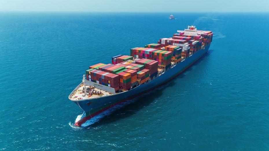 High-resolution view of a container ship navigating blue waters, reflecting scalable, sustainable, and international ocean freight logistics.