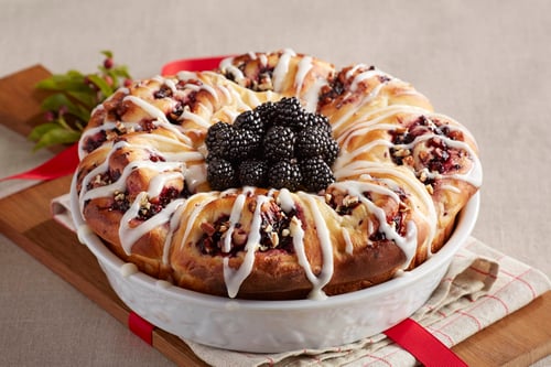 A bowl with blackberry pecan cinnamon rolls