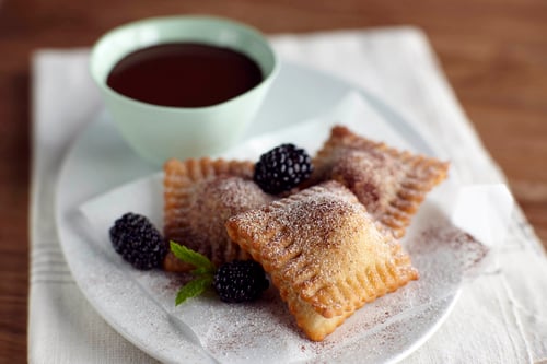 Plate of fried blackberry ravioli with chocolate fondue