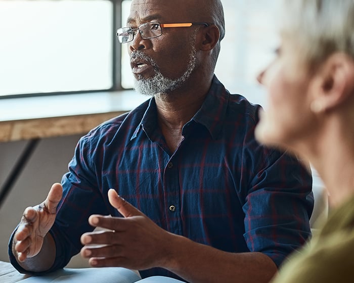 man speaking in meeting