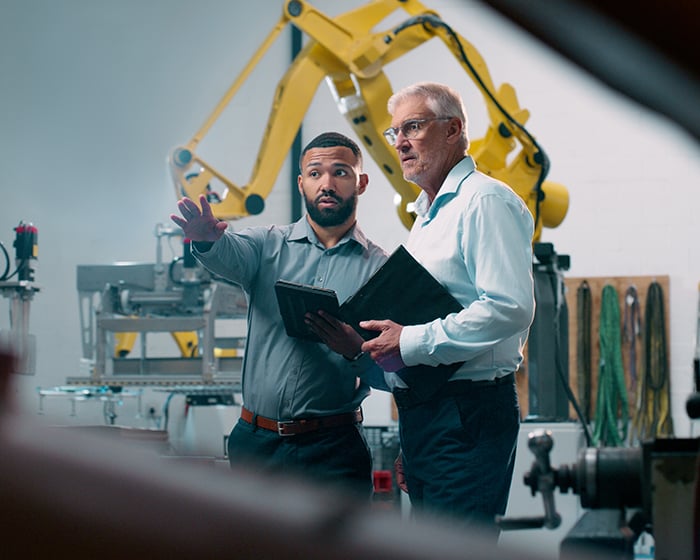 two men in a warehouse talking