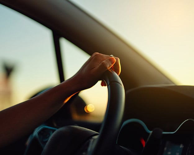 hand on steering wheel