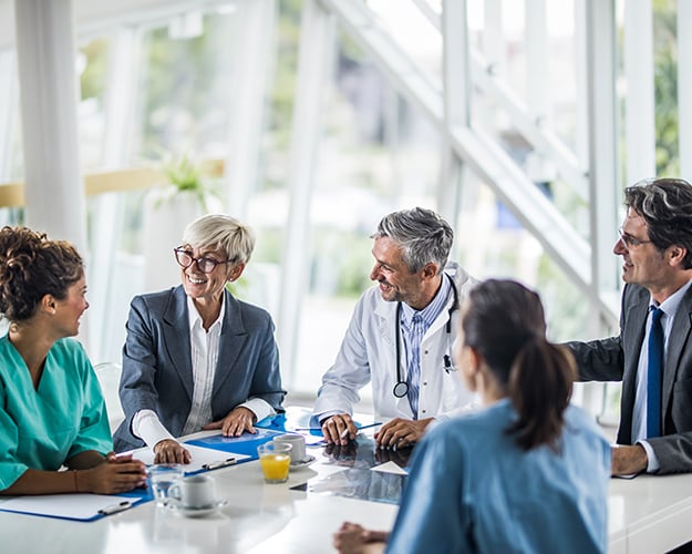 Group of healthcare workers sitting in a meeting