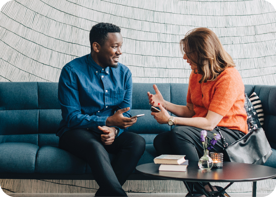 woman and man sitting on a couch and talking