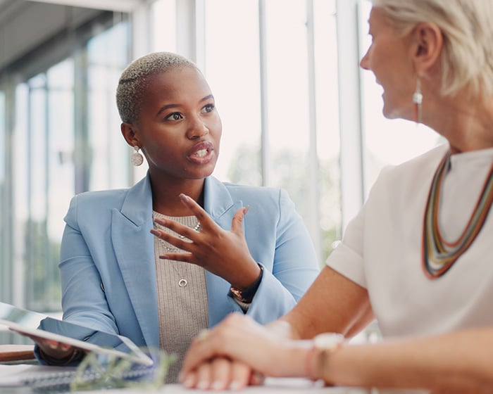 two coworkers talking in meeting