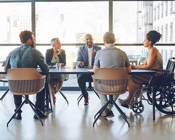 people sitting at a table in a meeting