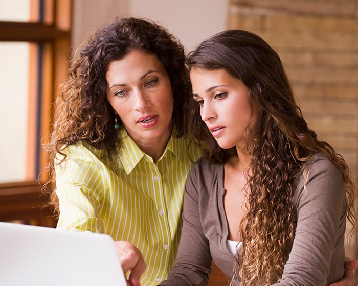 mother and daughter looking at computer