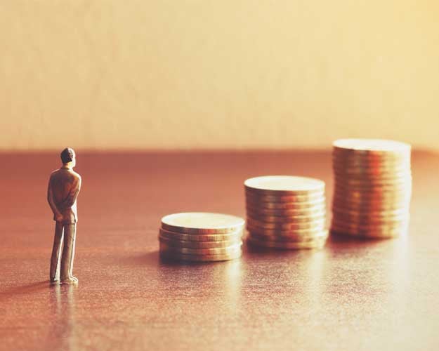 Miniature people looking future with stack coin
