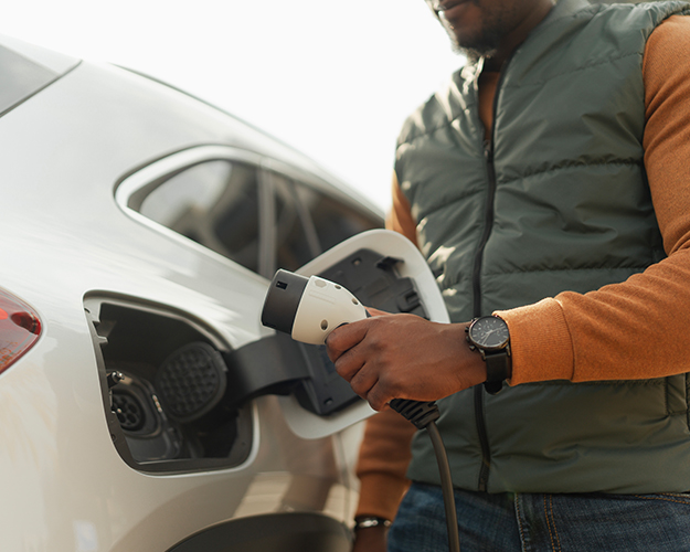 Man charging his electric car