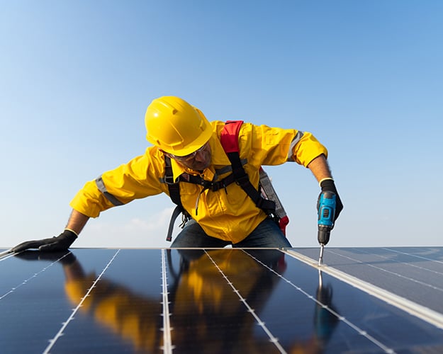 Man fixing or installing solar panels