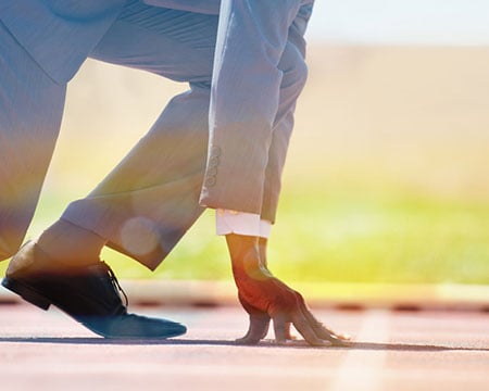 man-in-suite-preparing-to-run-a-race