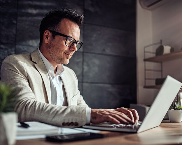 man working at his computer in office