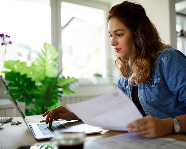 Woman working on her computer filling out a W9