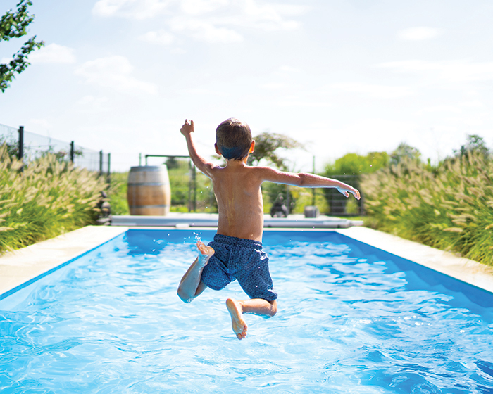 Child jumping into pool