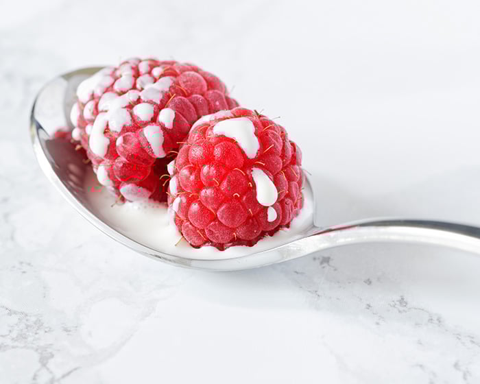 Raspberries and cream on a spoon