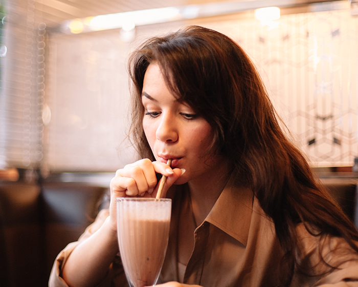 Woman enjoying a chocolate milkshake
