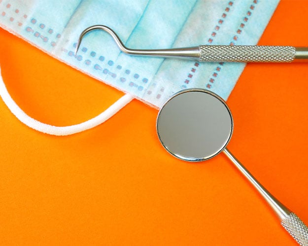 dental tools bright orange background