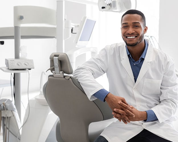 dentist in office posing for photo