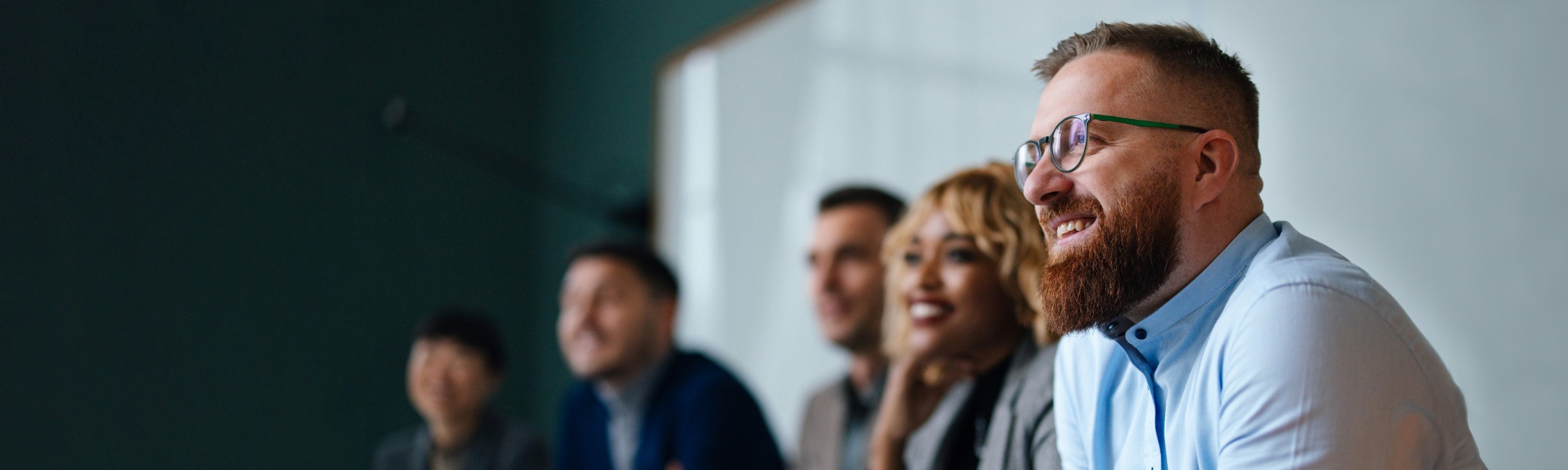 coworkers in a meeting, smiling
