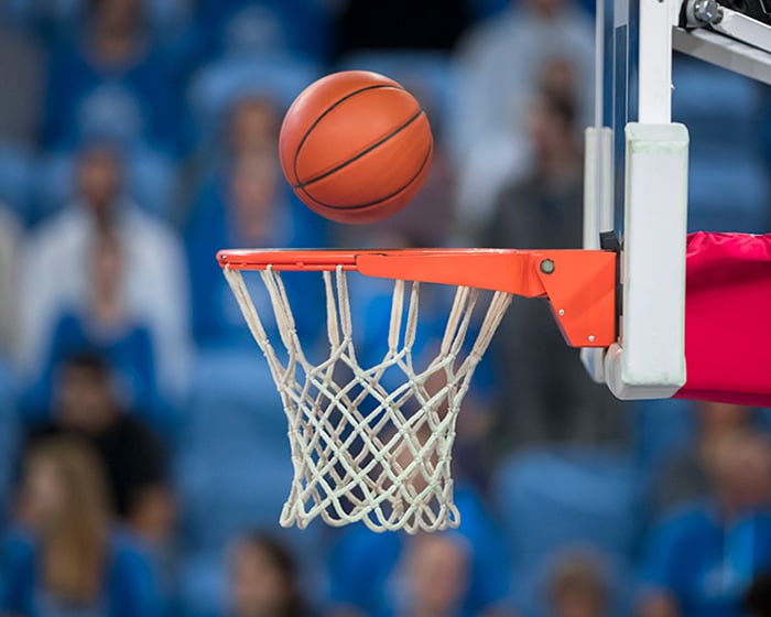 Basketball reaching to hoop