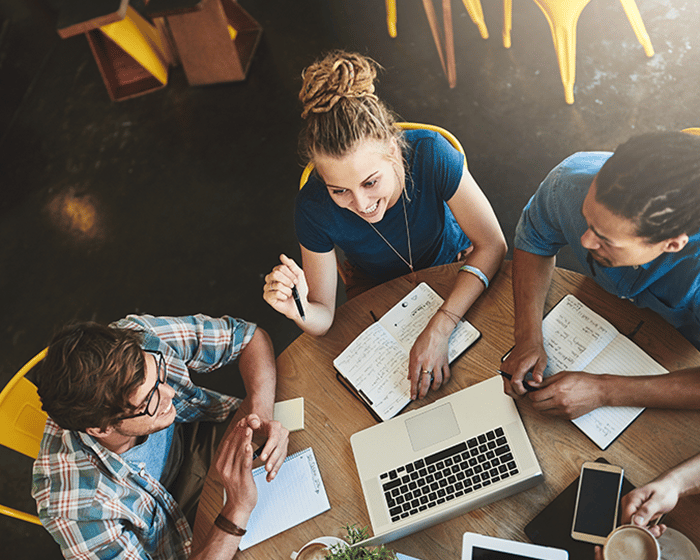 High angle shot of a group of students studying in a coffee shop