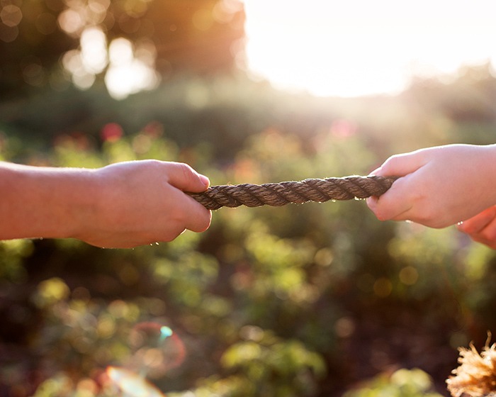 Hands tugging rope