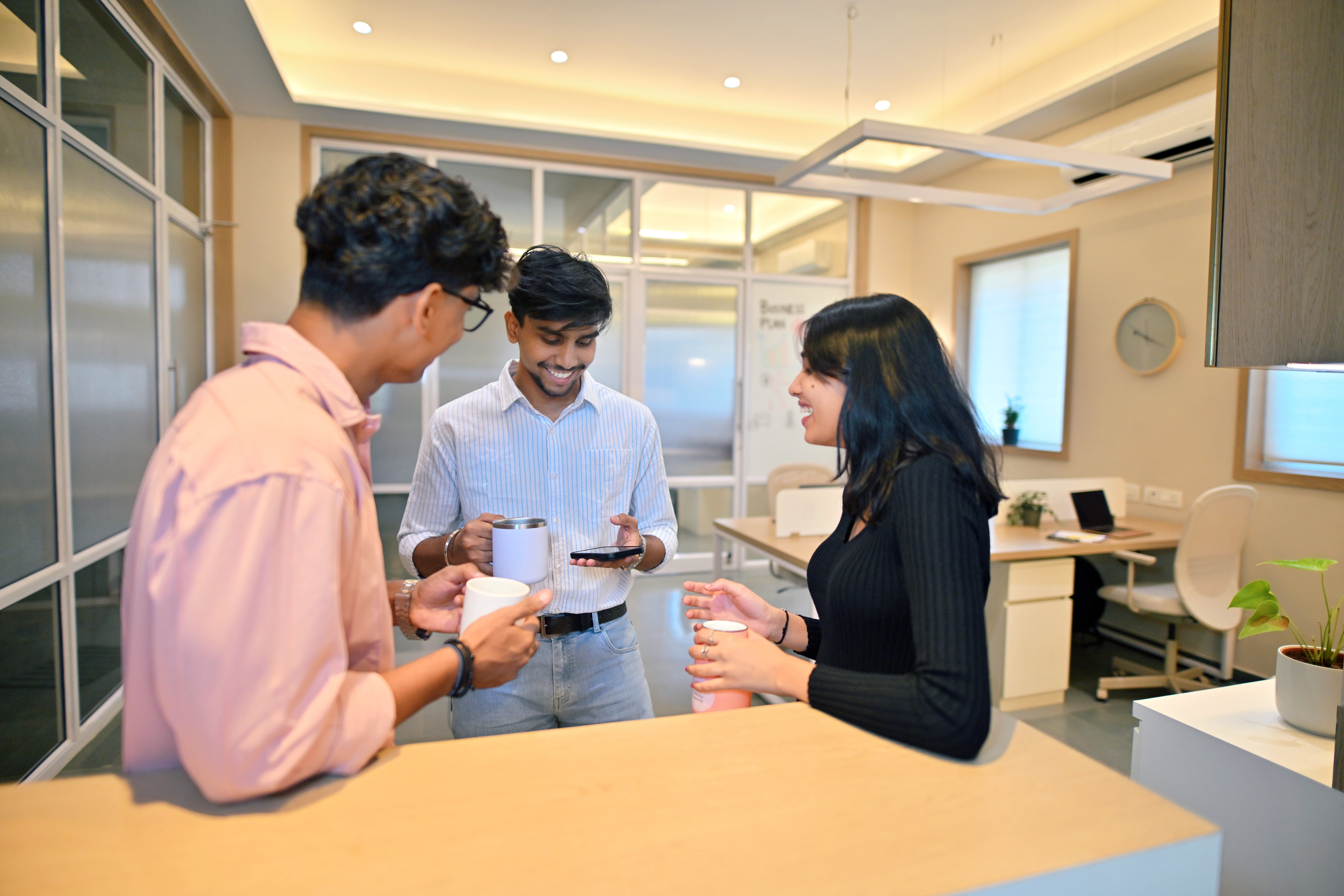 Young professionals enjoying coffee break in a modern office