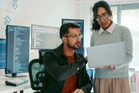 two coworkers looking at something on the computer
