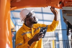 man working on manufacturing machine