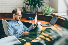man at desk looking at papers