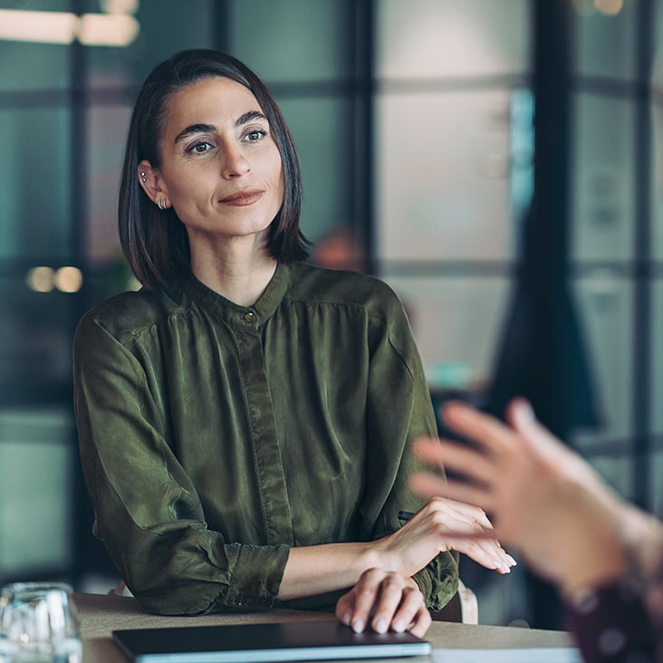 Focus on a female entrepreneur during a meeting