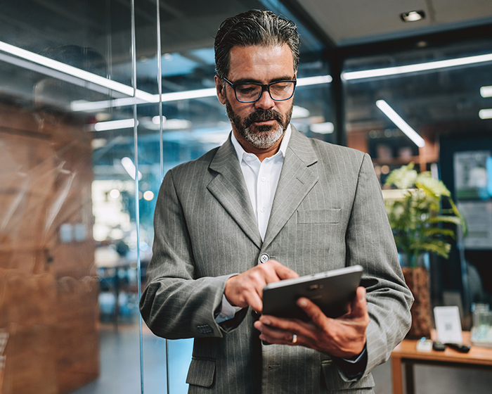 man looking at tablet while in office