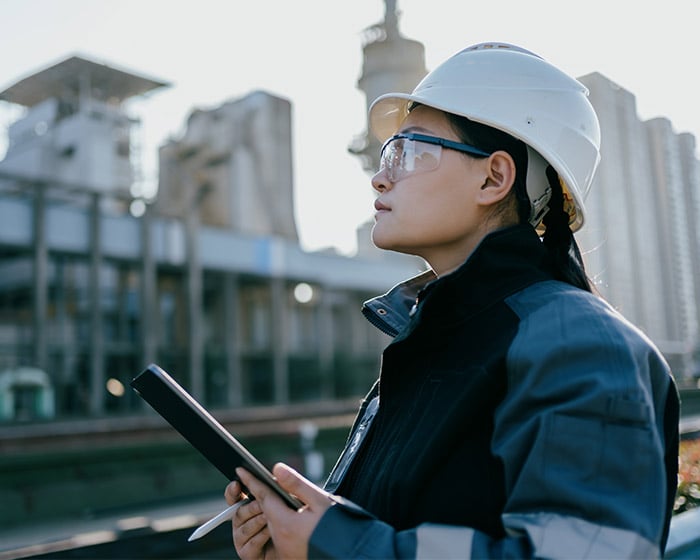 woman in hard hat holding a tablet