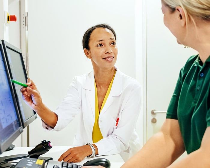 doctor talking to radiology technician about an x-ray