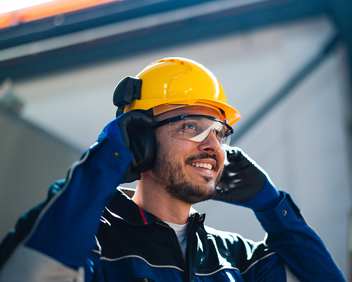 man wearing hard hat and ear protection