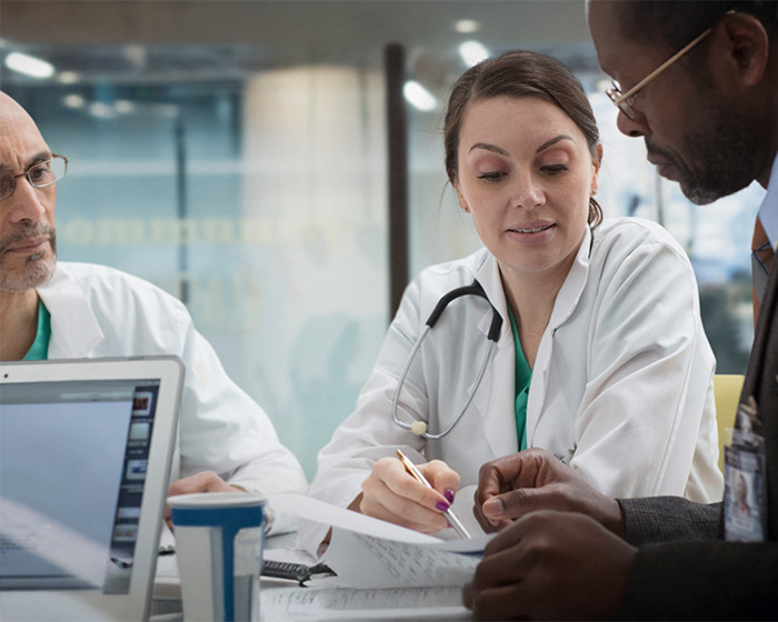 doctors and hospital admin going over paperwork
