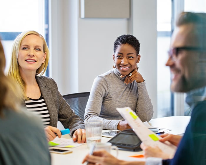 coworkers sitting at table in meeting