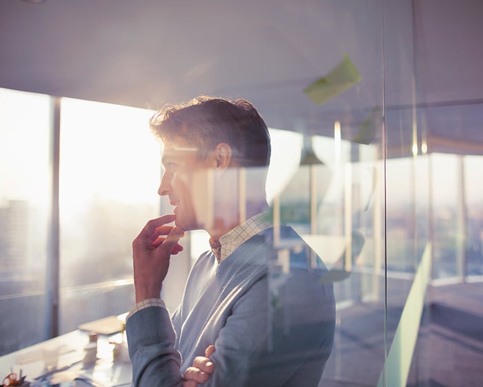 man looking out window