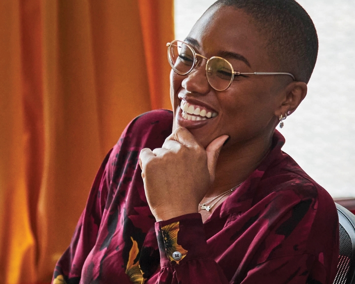 woman in glasses laughing and smiling