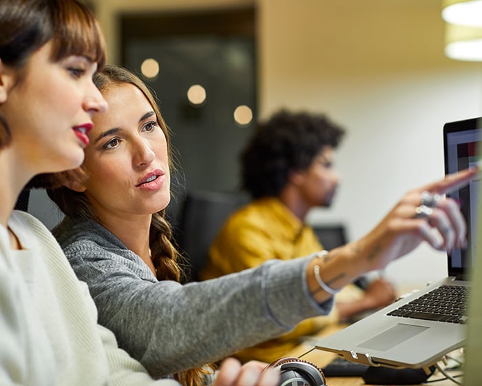 two women looking at computer