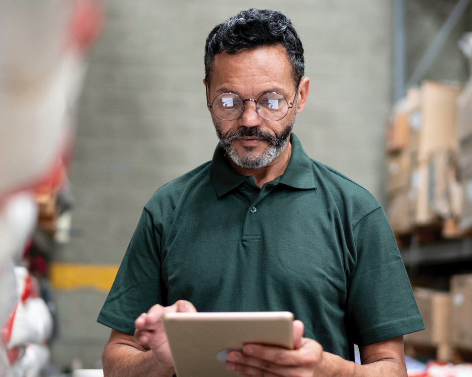man using tablet in warehouse
