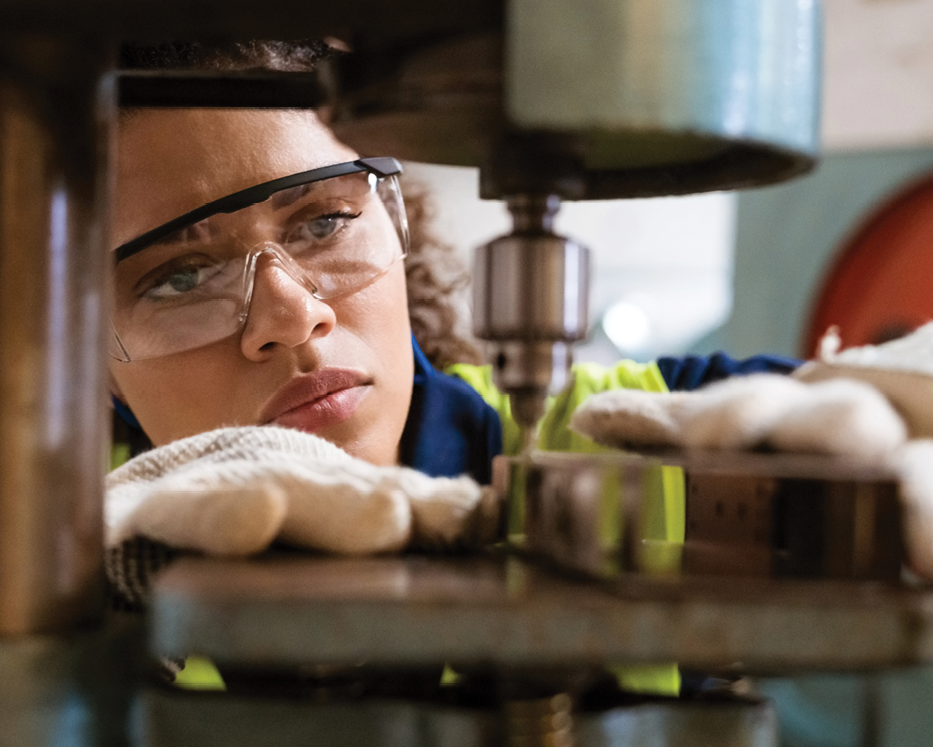 woman looking at manufacturing machinery