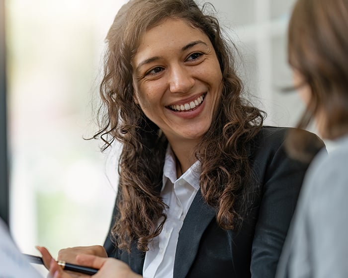 woman smiling at another woman