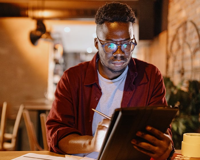 man writing on tablet