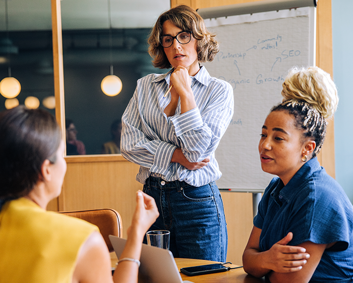 three women in a meeting