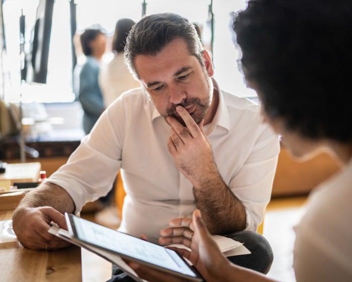 Two executives looking at something on a tablet