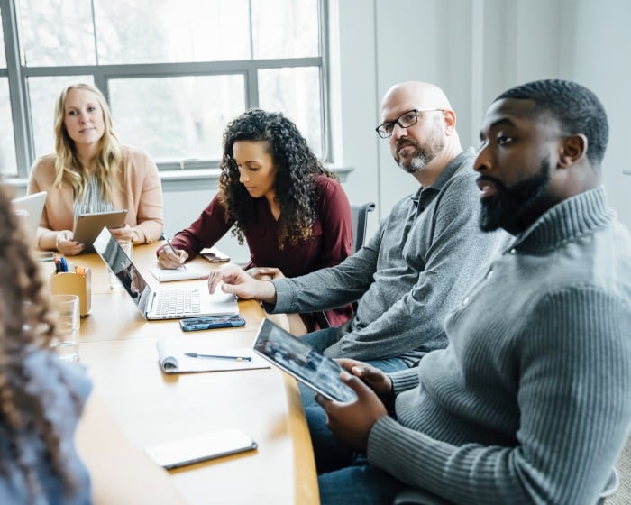 employees sitting at a table during a meeting