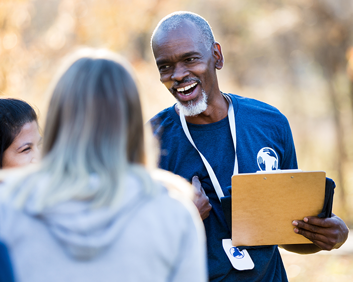 One man and two women speaking
