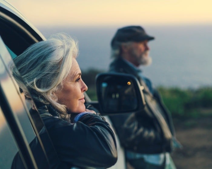 retirement aged woman looking out car window